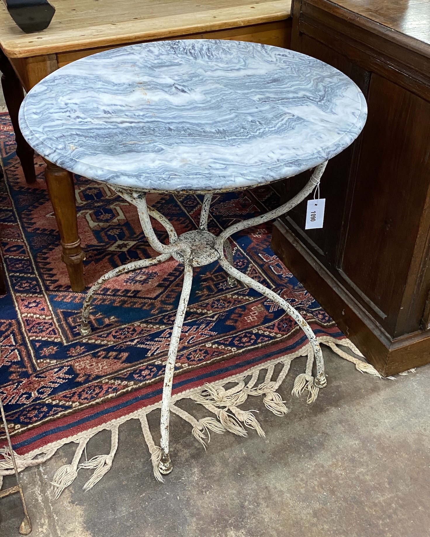 A painted wrought iron and reconstituted marble circular garden table, diameter 65cm, height 72cm